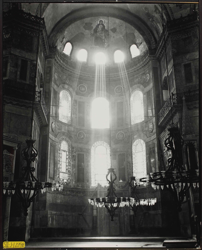 Image of Mary Theotokos above Koranic passages on rondels in apse/ mihrab of Hagia Sophia in Istanbul